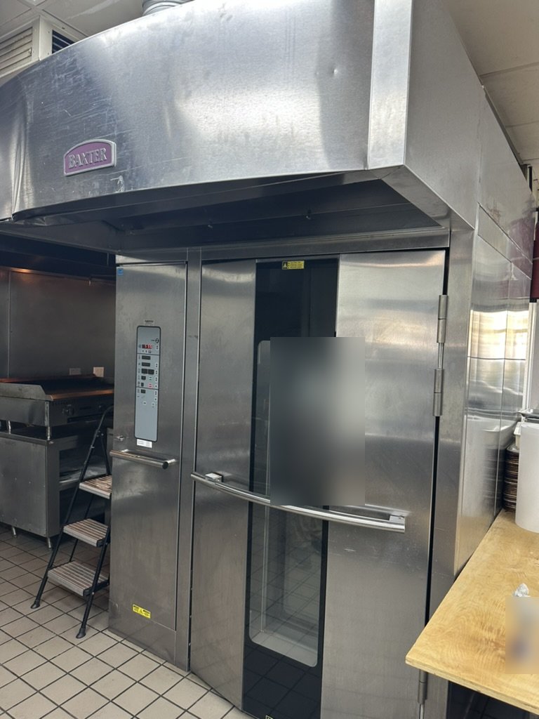 Baxter gas rotating rack oven with integrated hood in an in-store bakery