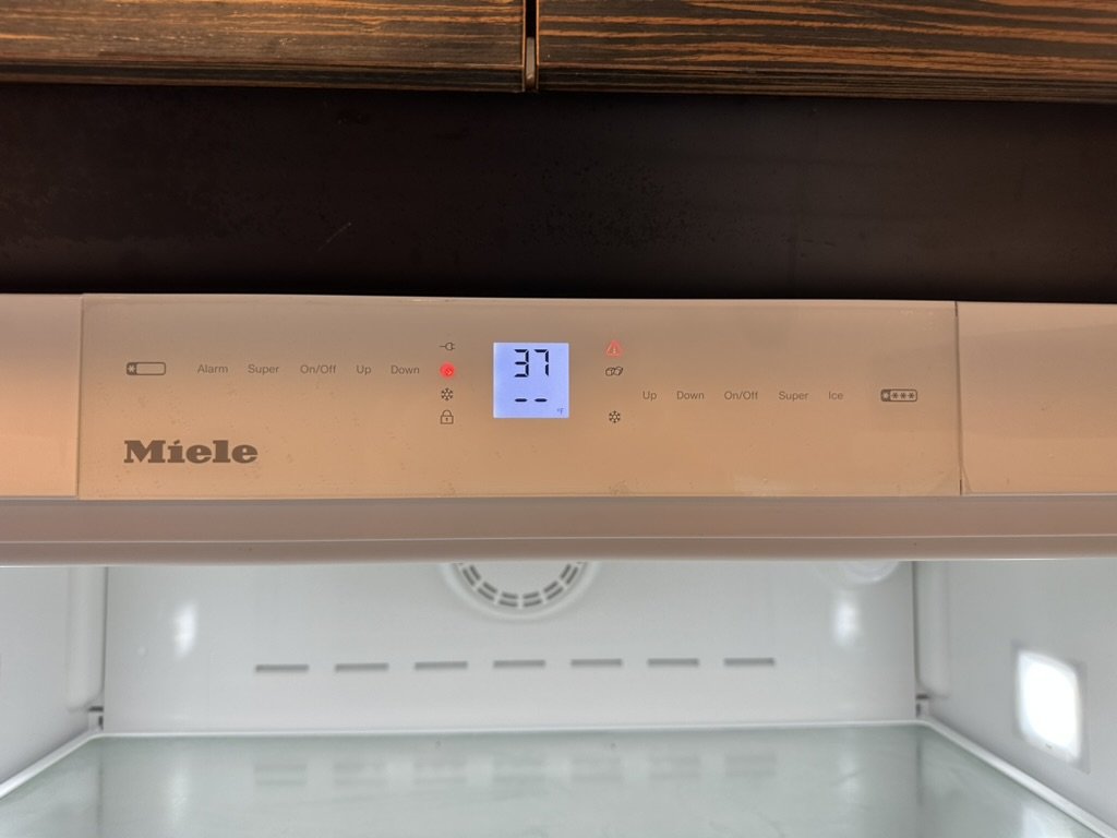 Miele refrigerator control panel with an alarm indicator lit