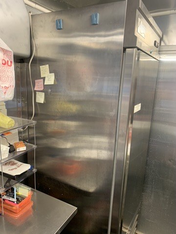 Avantco commercial reach-in refrigerator in a restaurant kitchen
