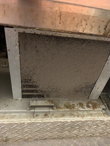 Heavily clogged condenser coil on a Avantco commercial refrigerator