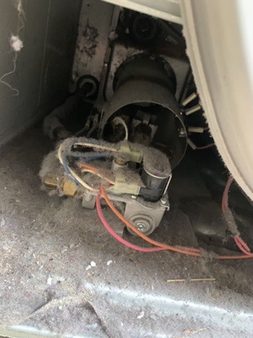 Burner igniter assembly on a Speed Queen commercial dryer during repair