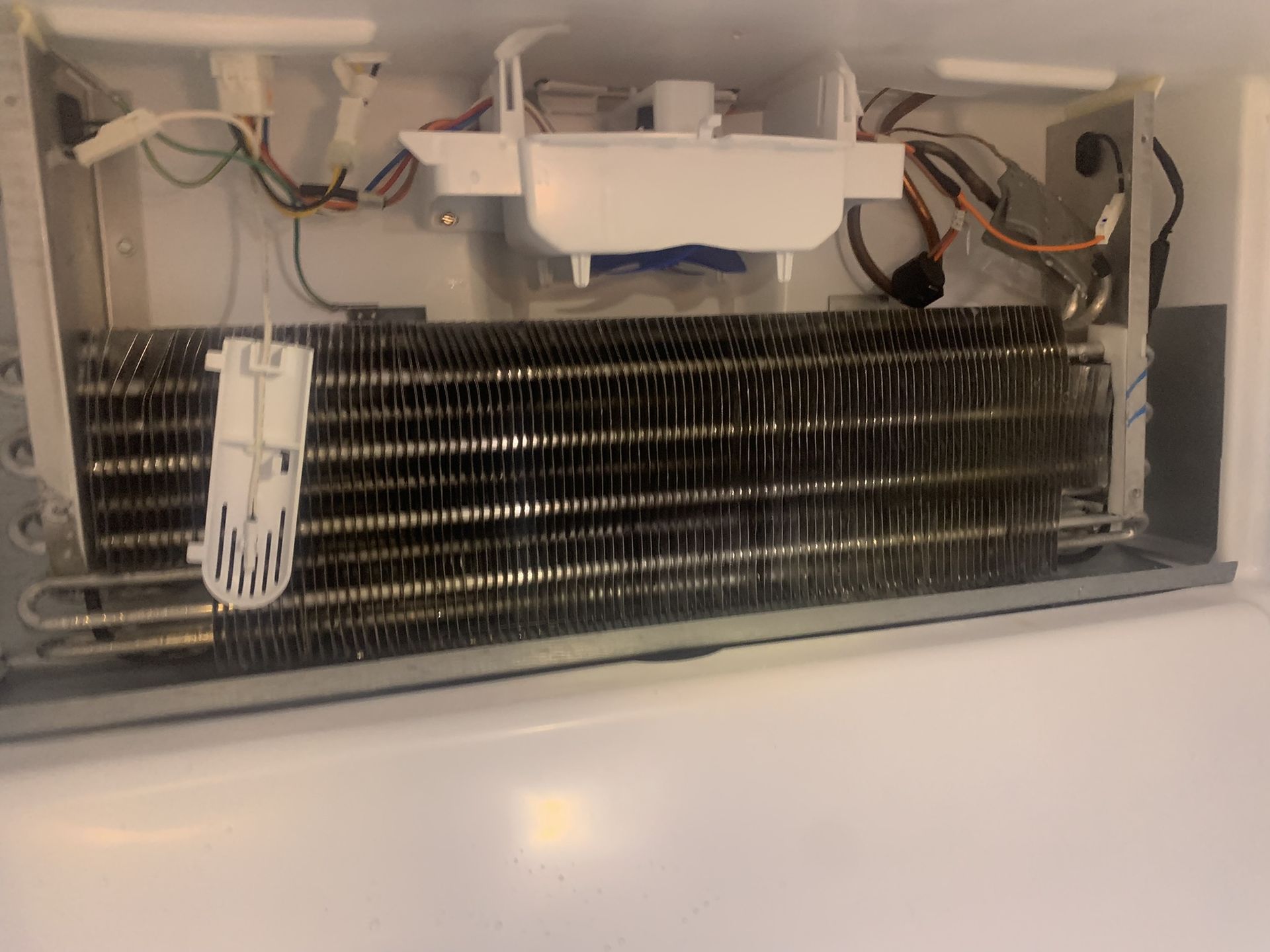 Evaporator coil and icemaker assembly inside a Whirlpool refrigerator